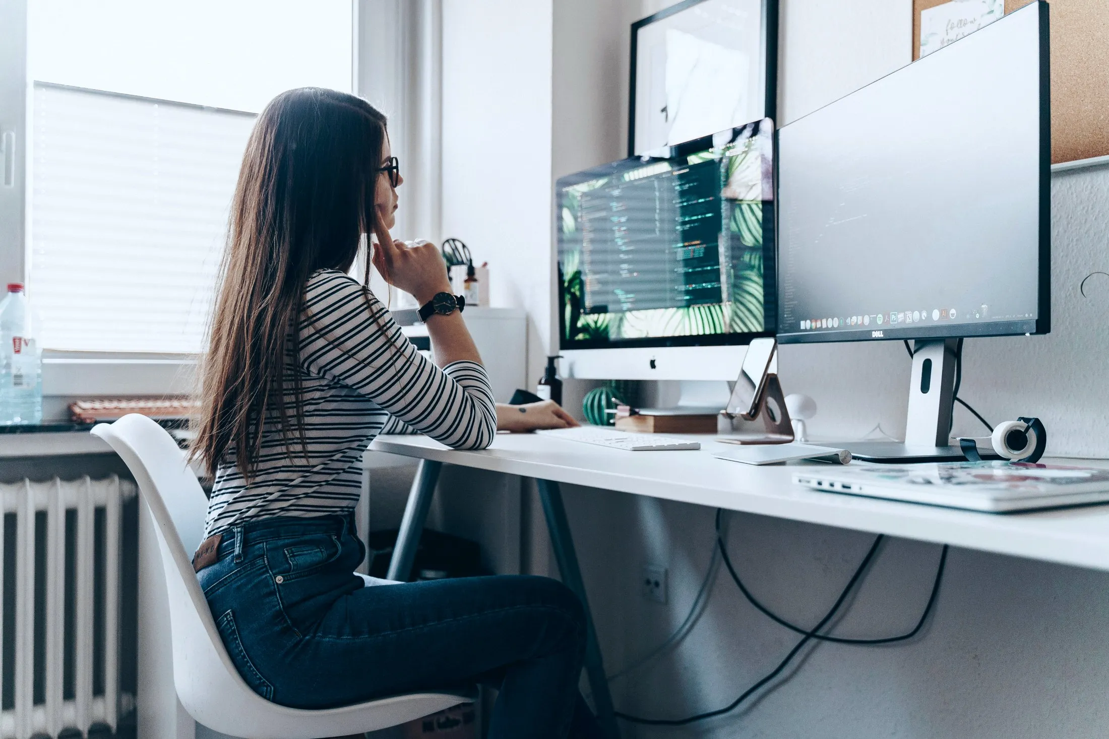 A person working at a computer in a bright office